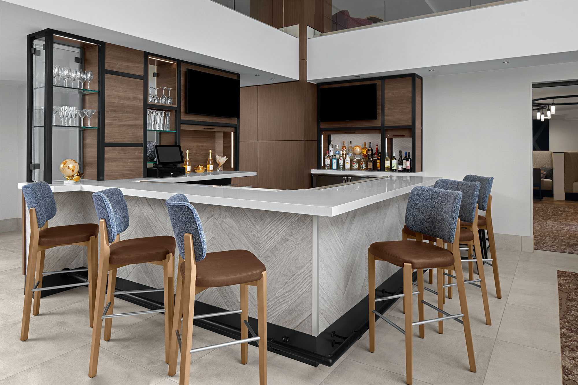 a bar with chairs and a shelf