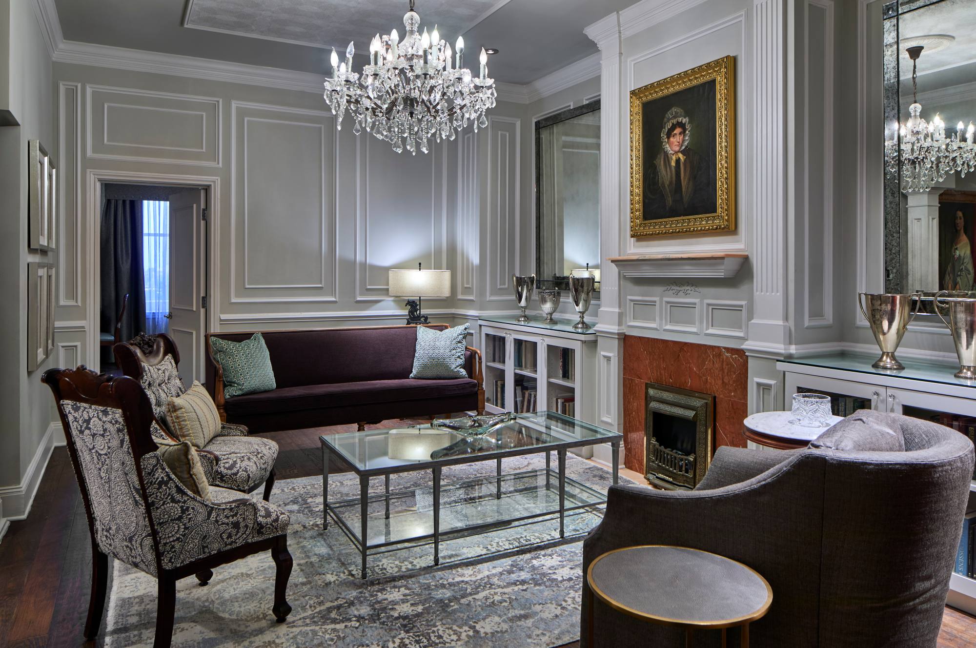 a living room with a chandelier and couches