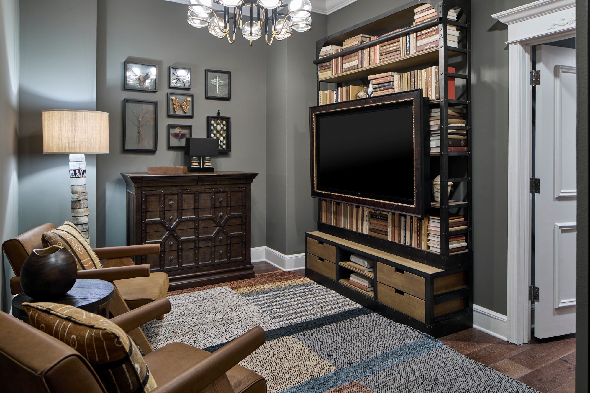 a room with a tv and bookshelf