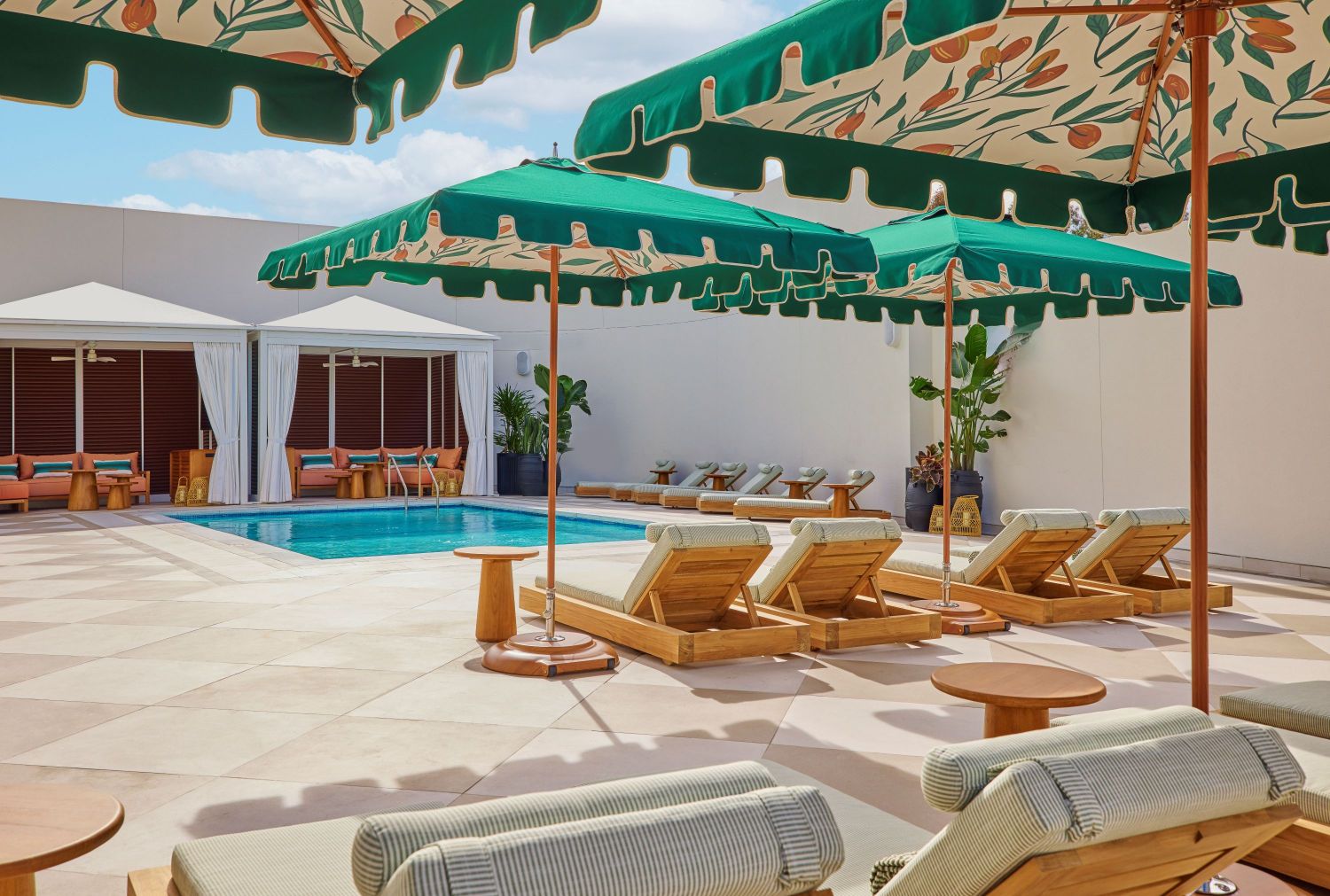 a pool with lounge chairs and umbrellas