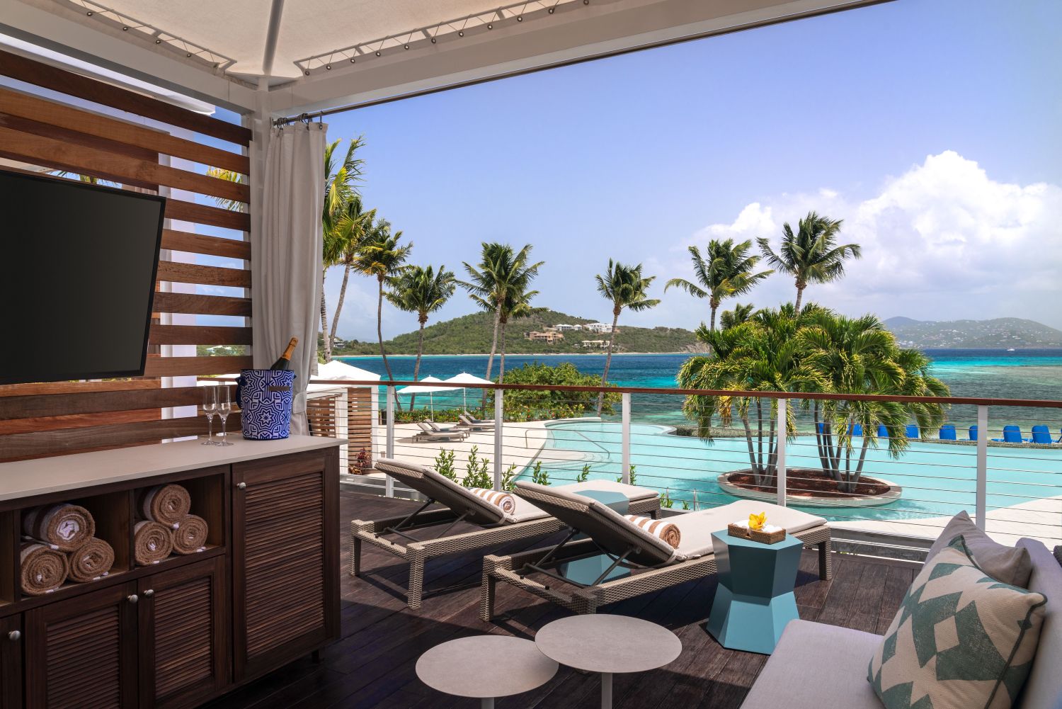 a room with a pool and a view of the ocean